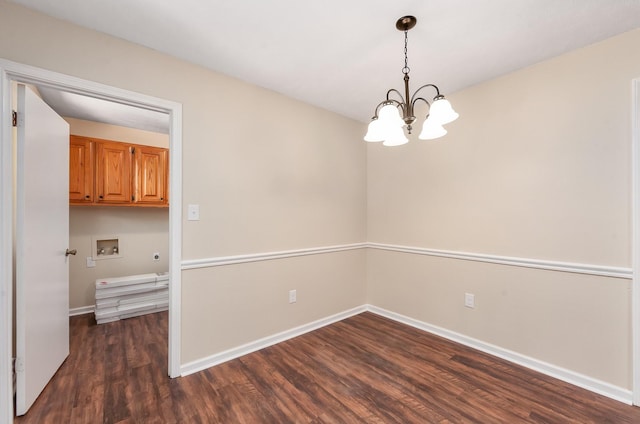 unfurnished dining area with a chandelier and dark wood-type flooring