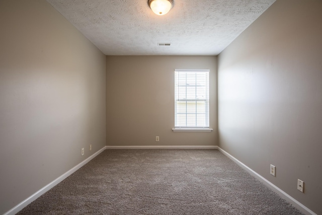 carpeted spare room featuring a textured ceiling