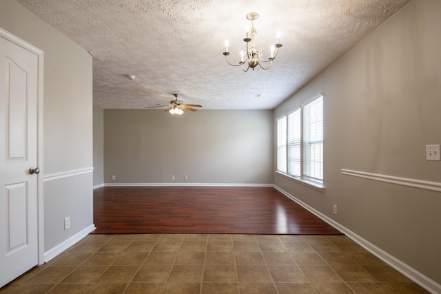 unfurnished room featuring ceiling fan with notable chandelier and a textured ceiling