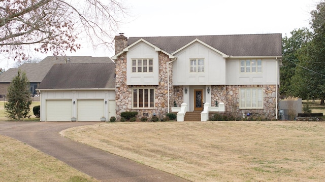 view of front of house featuring a front yard and a garage