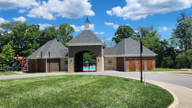 view of front of home with a playground and a front yard