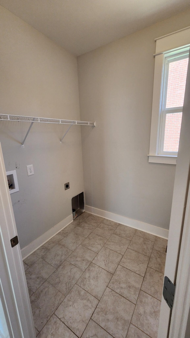 laundry room with hookup for a washing machine, light tile patterned floors, and hookup for an electric dryer