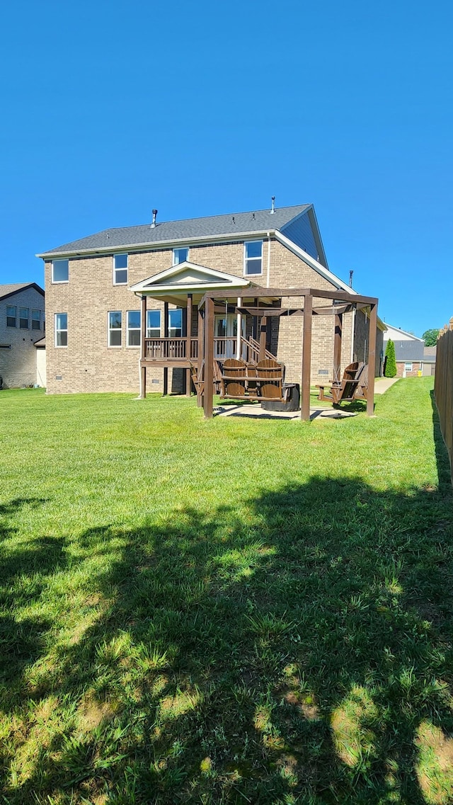 back of property featuring a lawn, a patio, and a deck