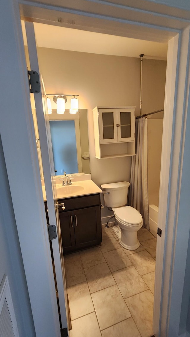 full bathroom with shower / bath combination with curtain, vanity, toilet, and tile patterned floors