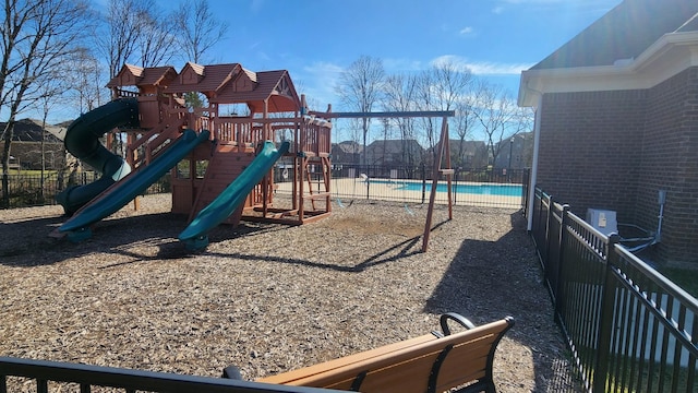 view of playground featuring a fenced in pool