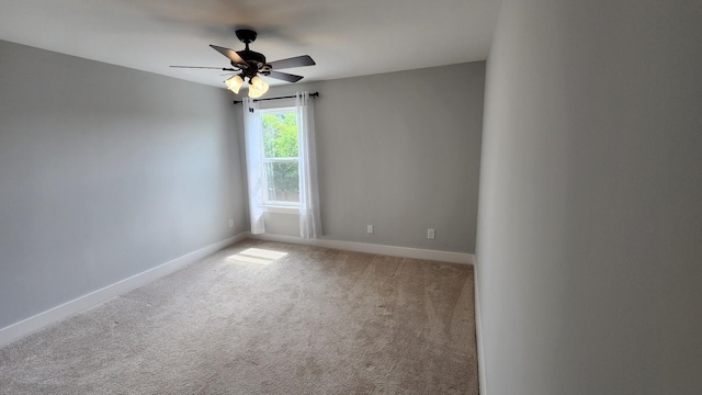 unfurnished room featuring ceiling fan and carpet floors