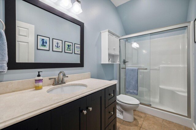 bathroom with tile floors, an enclosed shower, toilet, and vanity