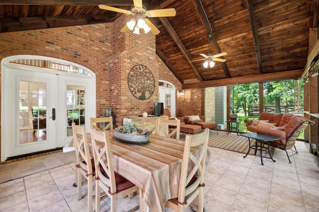 tiled dining space with high vaulted ceiling, ceiling fan, and wooden ceiling