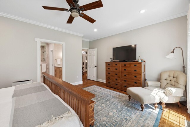 bedroom featuring hardwood / wood-style flooring, ornamental molding, connected bathroom, and ceiling fan