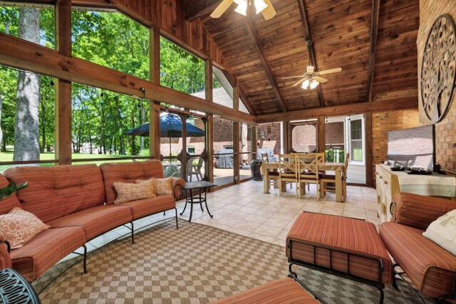 sunroom / solarium featuring wooden ceiling, a wealth of natural light, lofted ceiling with beams, and ceiling fan