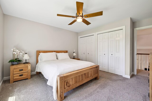 carpeted bedroom featuring two closets and ceiling fan