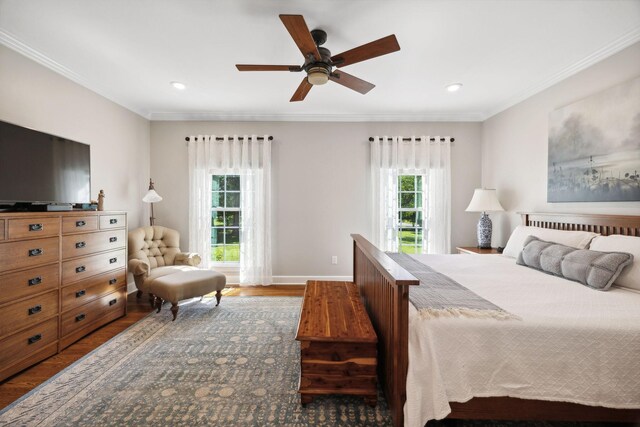 bedroom with ceiling fan, hardwood / wood-style flooring, crown molding, and multiple windows