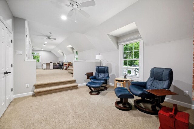 sitting room with carpet floors, ceiling fan, and vaulted ceiling