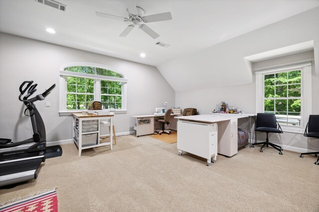 carpeted home office with a healthy amount of sunlight, ceiling fan, and lofted ceiling