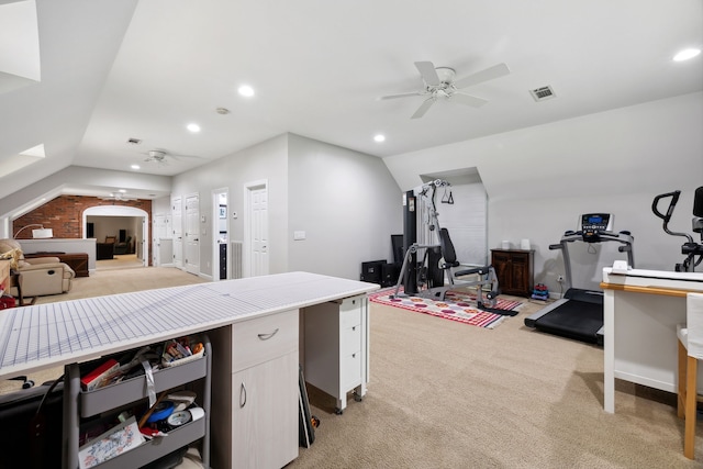 interior space with vaulted ceiling, light carpet, and ceiling fan