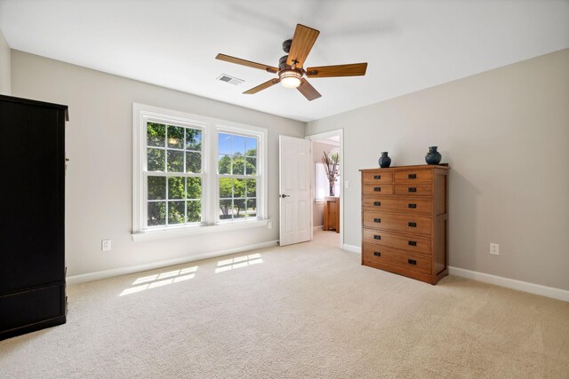 unfurnished bedroom featuring light carpet and ceiling fan