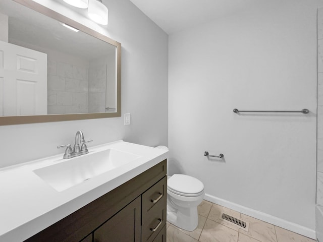 bathroom with vanity, toilet, and a shower