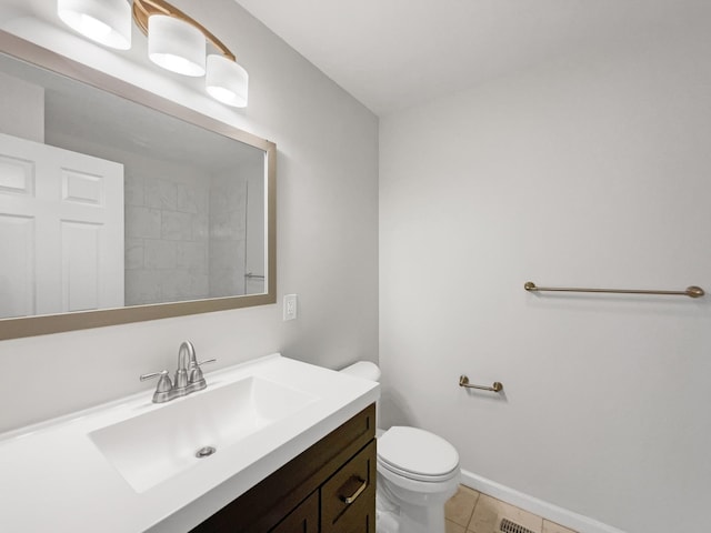 bathroom featuring tile patterned flooring, vanity, and toilet