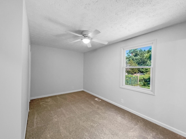 unfurnished room featuring ceiling fan, carpet floors, and a textured ceiling