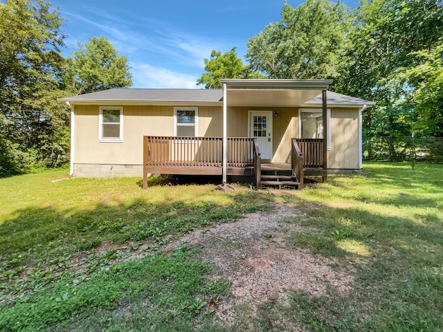 rear view of house with a lawn and a wooden deck