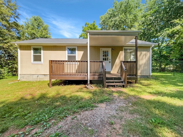 view of front of house featuring a front lawn and a deck