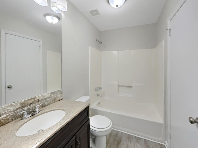 full bathroom with vanity, shower / tub combination, decorative backsplash, toilet, and wood-type flooring