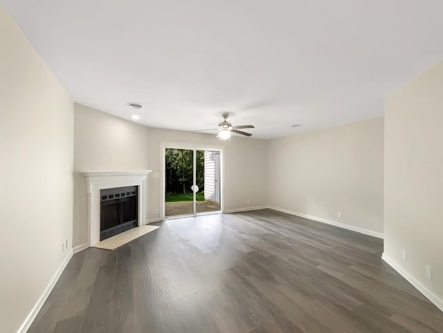 unfurnished living room with dark hardwood / wood-style flooring and ceiling fan