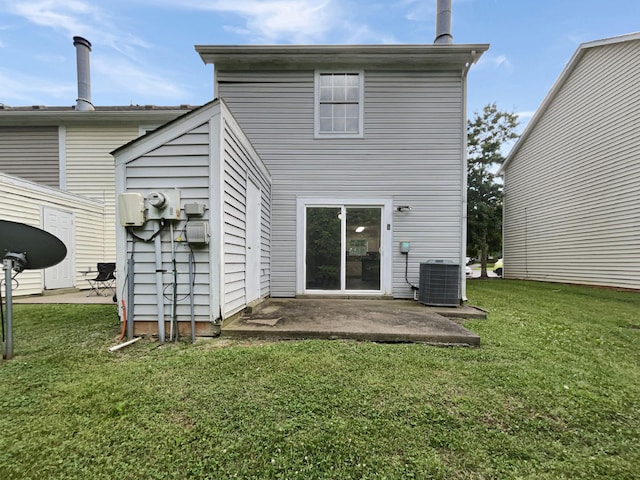 rear view of property featuring a patio area, a yard, and cooling unit