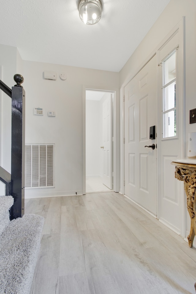 entrance foyer with light hardwood / wood-style flooring