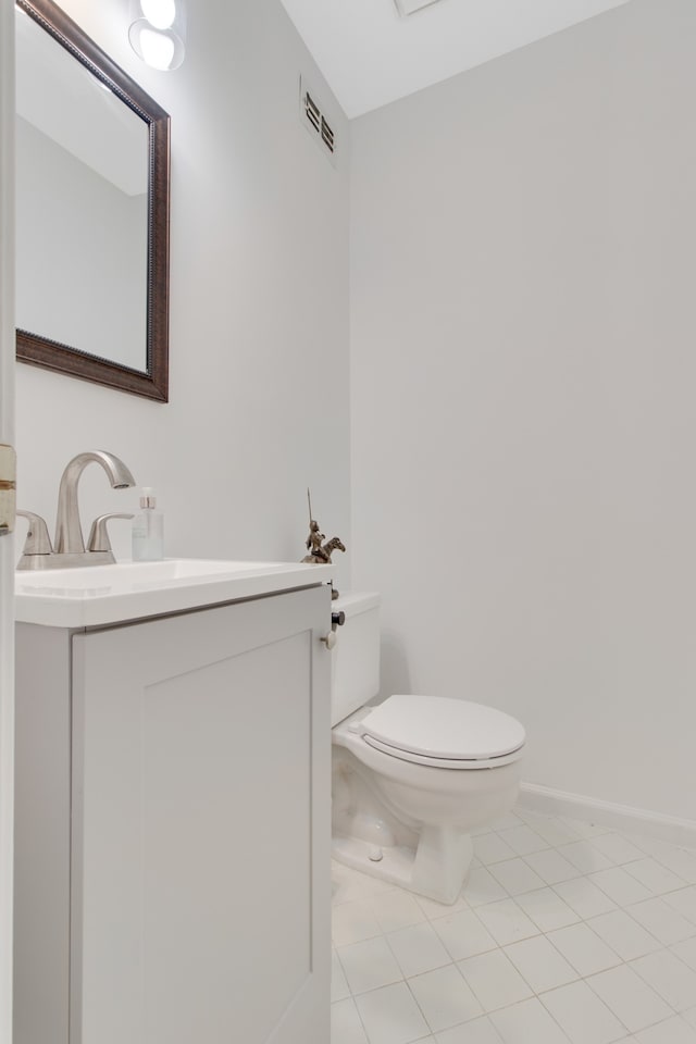 bathroom featuring tile patterned floors, toilet, and vanity