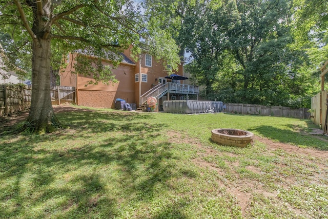 view of yard with an outdoor fire pit and a deck