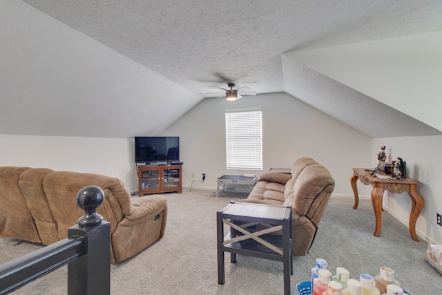 carpeted living room with ceiling fan, vaulted ceiling, and a textured ceiling