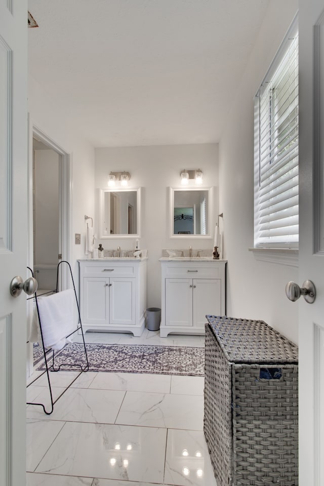 bathroom featuring tile patterned flooring and vanity