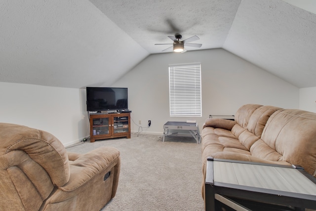 living room featuring ceiling fan, carpet floors, lofted ceiling, and a textured ceiling