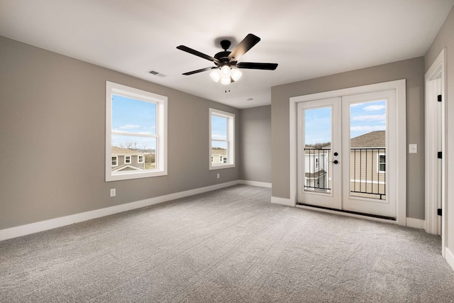 spare room with light carpet, french doors, and ceiling fan