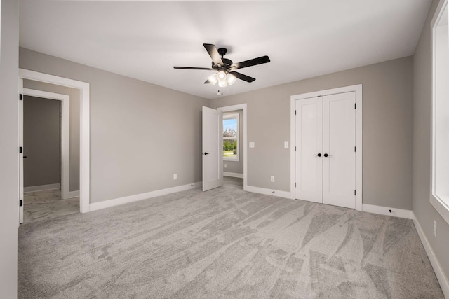 interior space featuring light colored carpet and ceiling fan