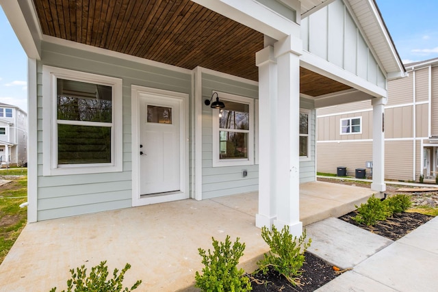 property entrance featuring covered porch and central AC