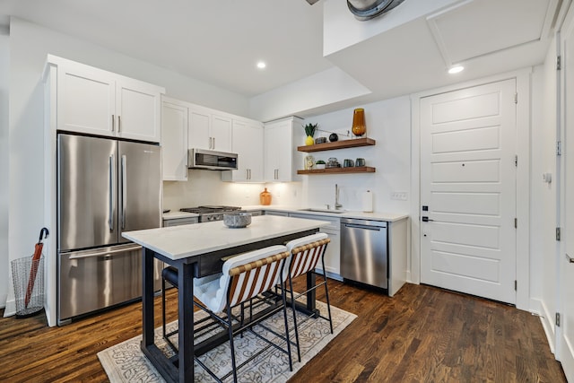 kitchen featuring dark hardwood / wood-style floors, stainless steel appliances, sink, and white cabinetry