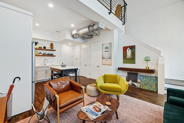 living room with dark hardwood / wood-style floors and sink