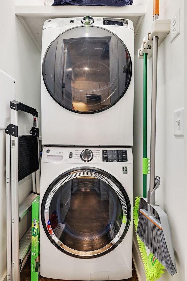 clothes washing area with stacked washer / drying machine