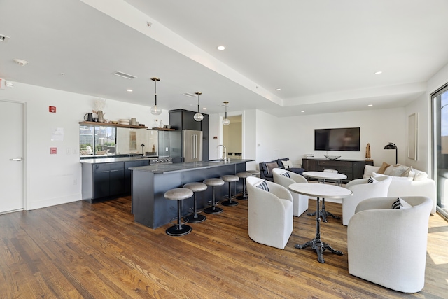 living room featuring sink and hardwood / wood-style floors