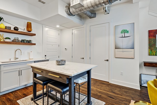 kitchen with sink, white cabinets, and dark wood-type flooring