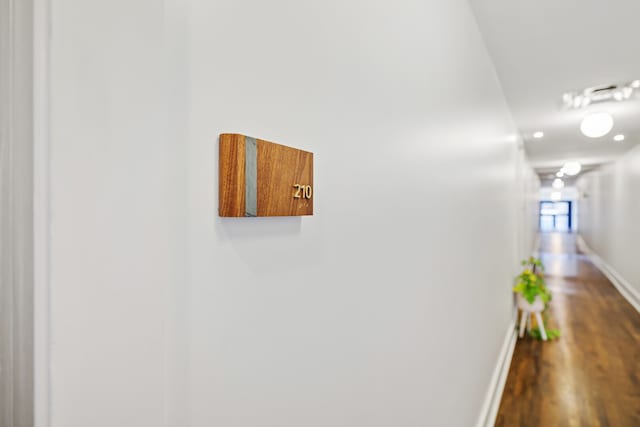 hallway with hardwood / wood-style flooring