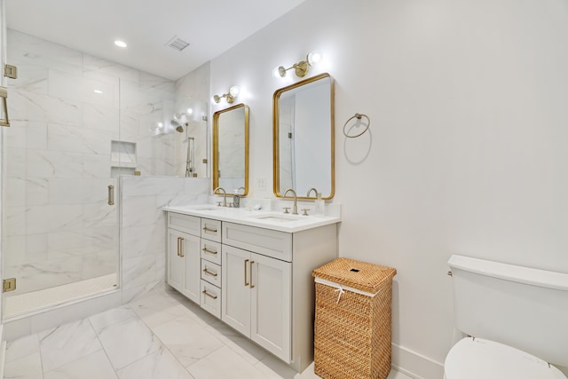 bathroom featuring a shower with shower door, dual bowl vanity, toilet, and tile floors