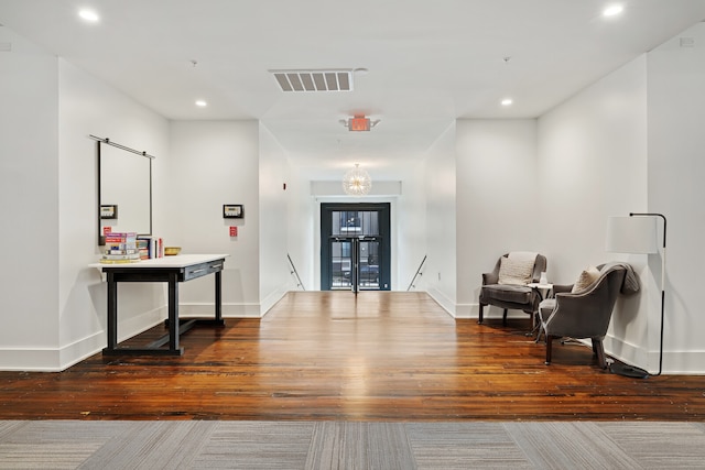 corridor with hardwood / wood-style floors