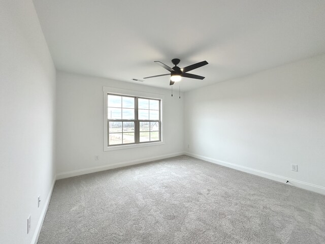 unfurnished room featuring ceiling fan and carpet floors