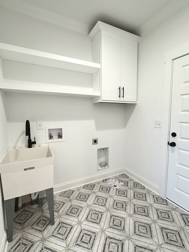 clothes washing area featuring cabinets, hookup for a washing machine, and hookup for an electric dryer