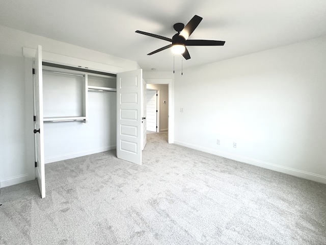 unfurnished bedroom with light carpet, a closet, and ceiling fan