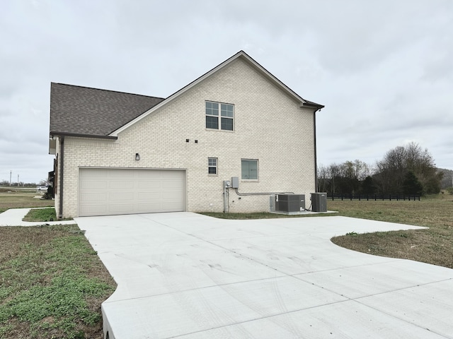 view of property exterior featuring a garage and central AC