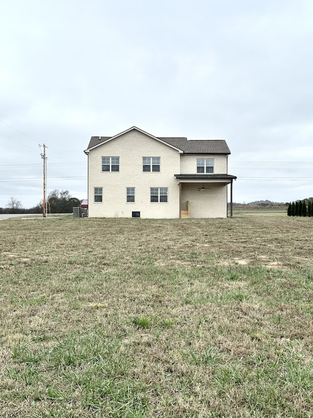 view of side of home with a yard